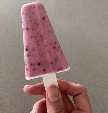reviewer holding up a homemade pink popsicle