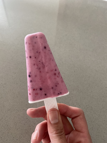 reviewer holding up a homemade pink popsicle