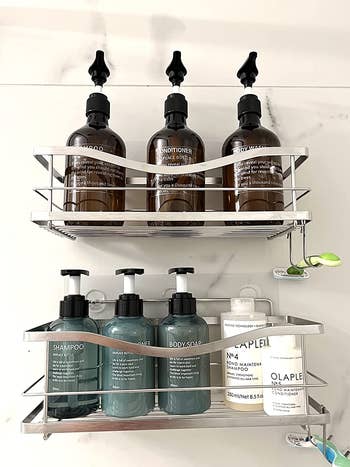 Reviewer photo of silver shelves holding various shampoo and conditioner bottles in the shower