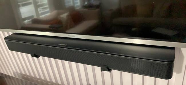 reviewers sound bar under their mounted TV