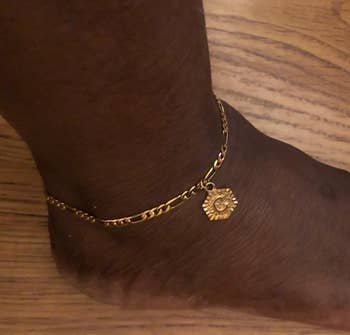 Reviewer wearing gold ankle bracelet