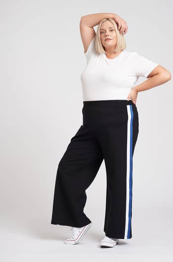 a different model wearing the pants with blue stripes