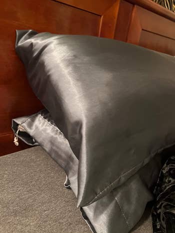 reviewer image of pillows in space grey satin pillowcases