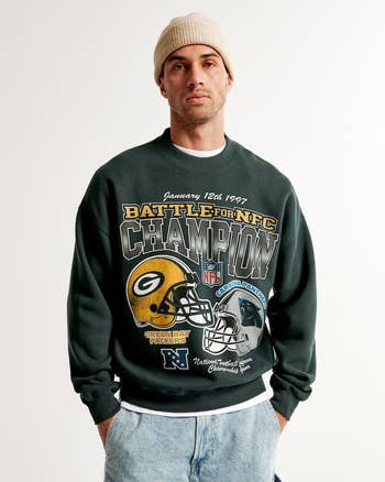 a model in a vintage styled green bay packers sweatshirt