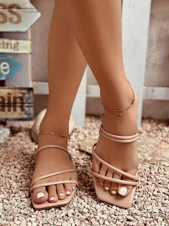 model wearing strappy sandals in tan