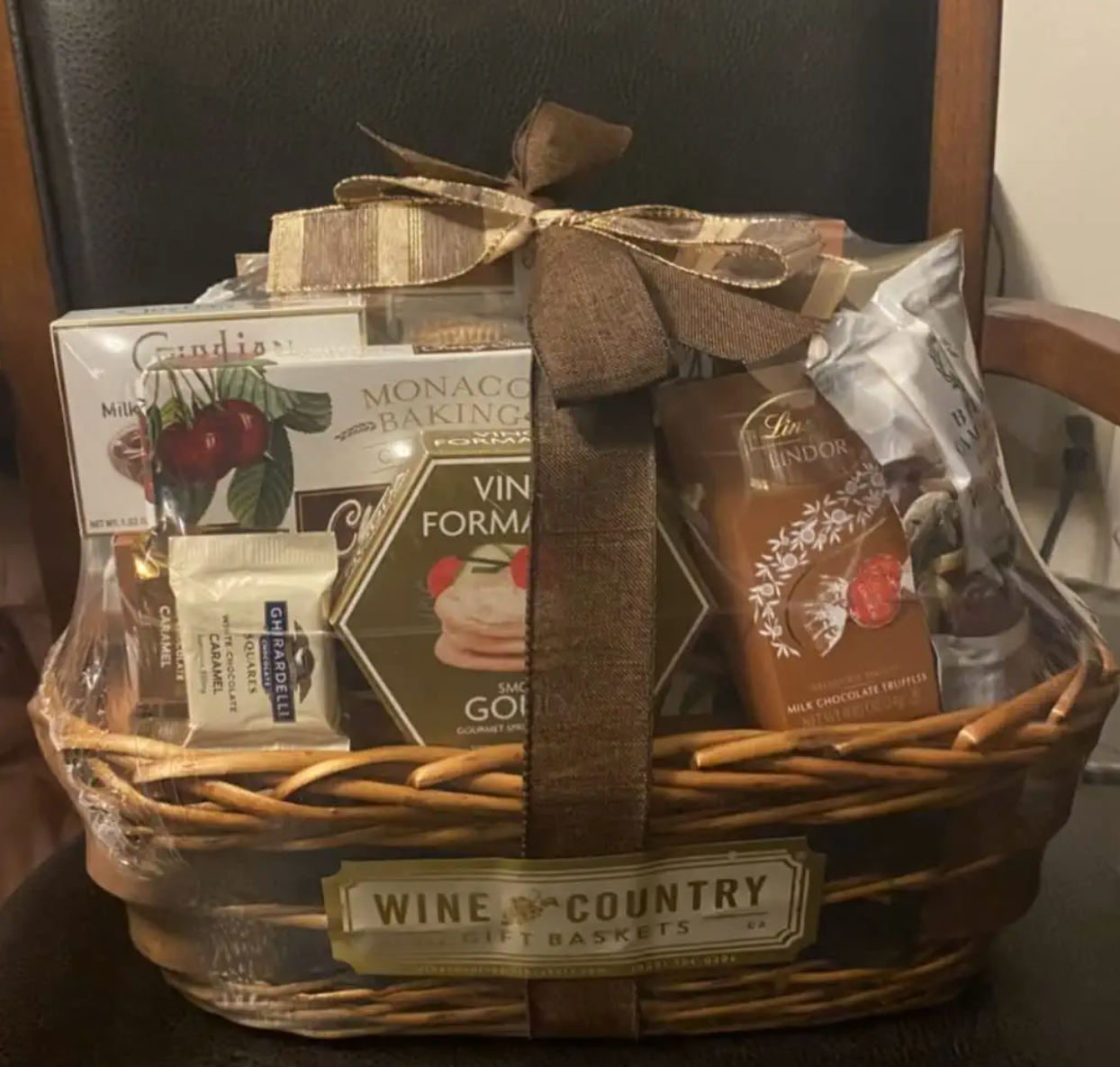 Reviewer image of thick wicker basket with boxes of chocolates, crackers, and cookies