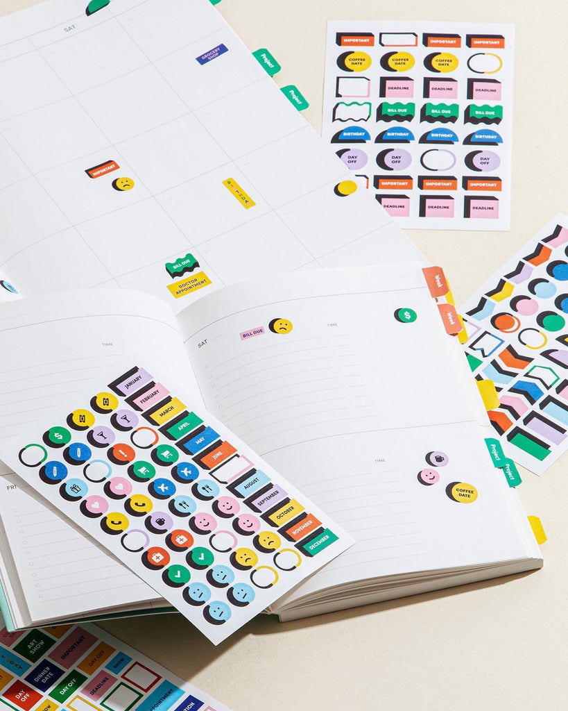 the sticker sheets laying next to an open planner