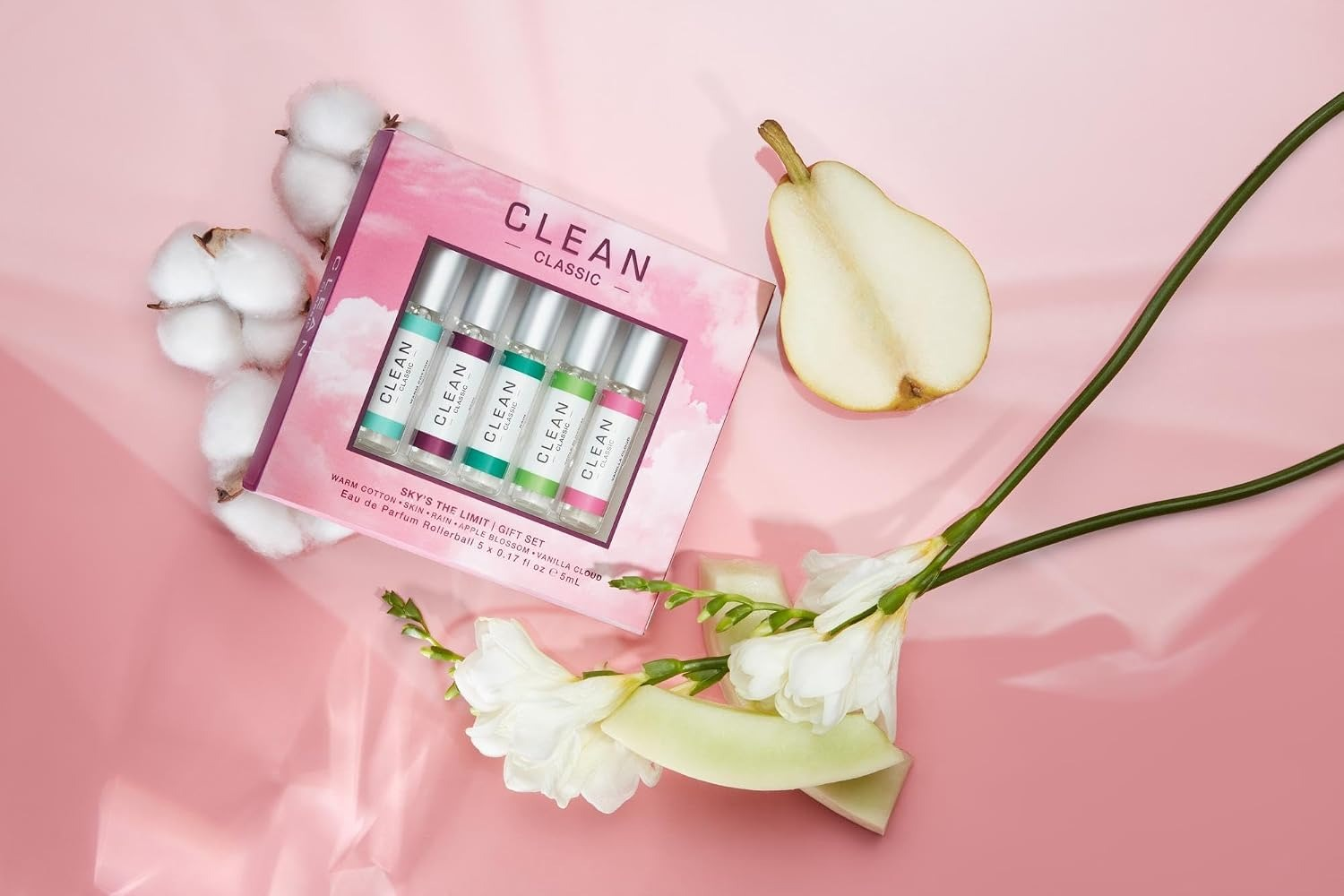 Perfume acquisition  acceptable   with 5  mini bottles, cotton, pear, and achromatic  flowers connected  a brushed  pinkish  background. Featured successful  a buying  article