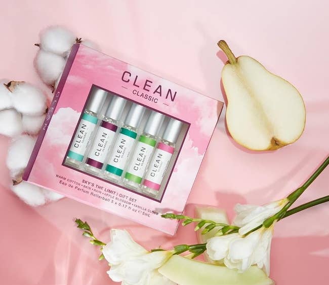 Perfume acquisition acceptable with 5 mini bottles, cotton, pear, and achromatic flowers connected a brushed pinkish background. Featured successful a buying article