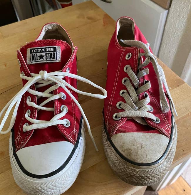 reviewer photo comparing a dirty shoe to one that was cleaned using the cleaning kit