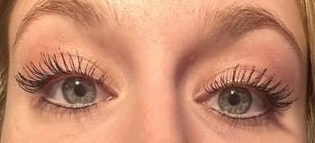 Reviewer's lashes after applying the mascara looking incredibly long as if they were falsies