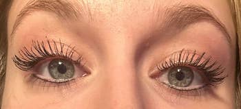 Reviewer's lashes after applying the mascara looking incredibly long as if they were falsies