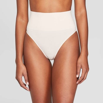 front of a model wearing a nude, seamless, and high-waisted thong