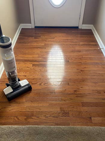 a shiny wood floor cleaned using the vacuum