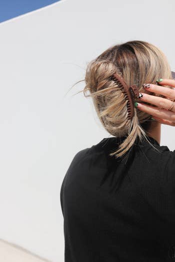 a model wearing the brown claw clip