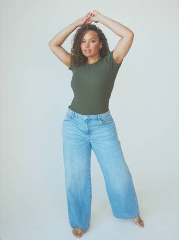 another model wearing it in olive green with baggy jeans