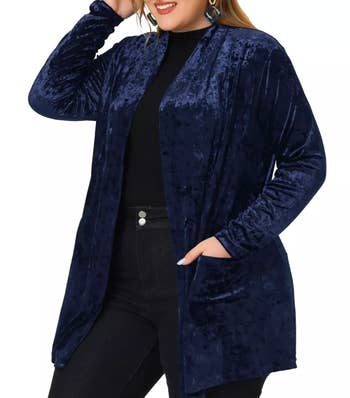 A model wearing a blue velvet cardigan