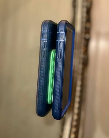 Two smartphones with protective cases, viewed from the side, showing their thickness and button placements