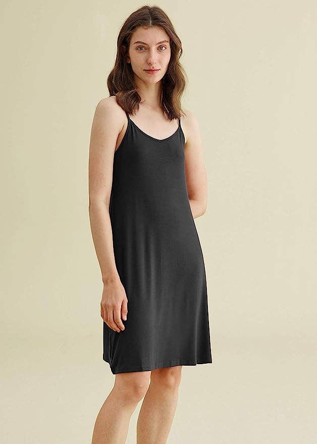 A model in the black knee-length slip dress 