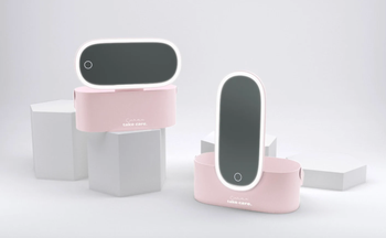 two pink makeup cases with lighted mirrors attached
