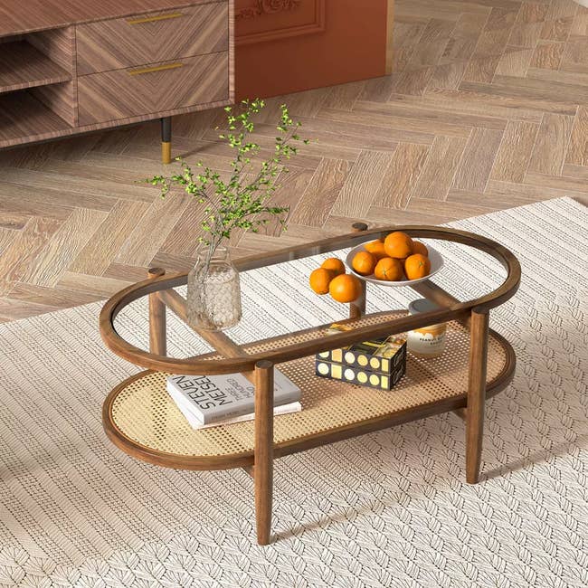 Oval solid  java  array  with books, oranges, and a vase connected  top, acceptable   successful  a modern   surviving  country   with a geometric rug and wood   flooring