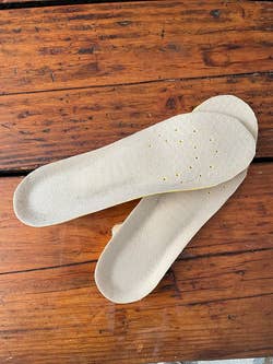 reviewer photo of the front side of the gray memory foam insoles