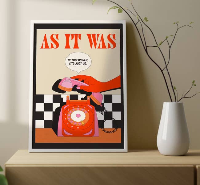 An illustrated print of a person putting a rotary phone on its cradle with the words 