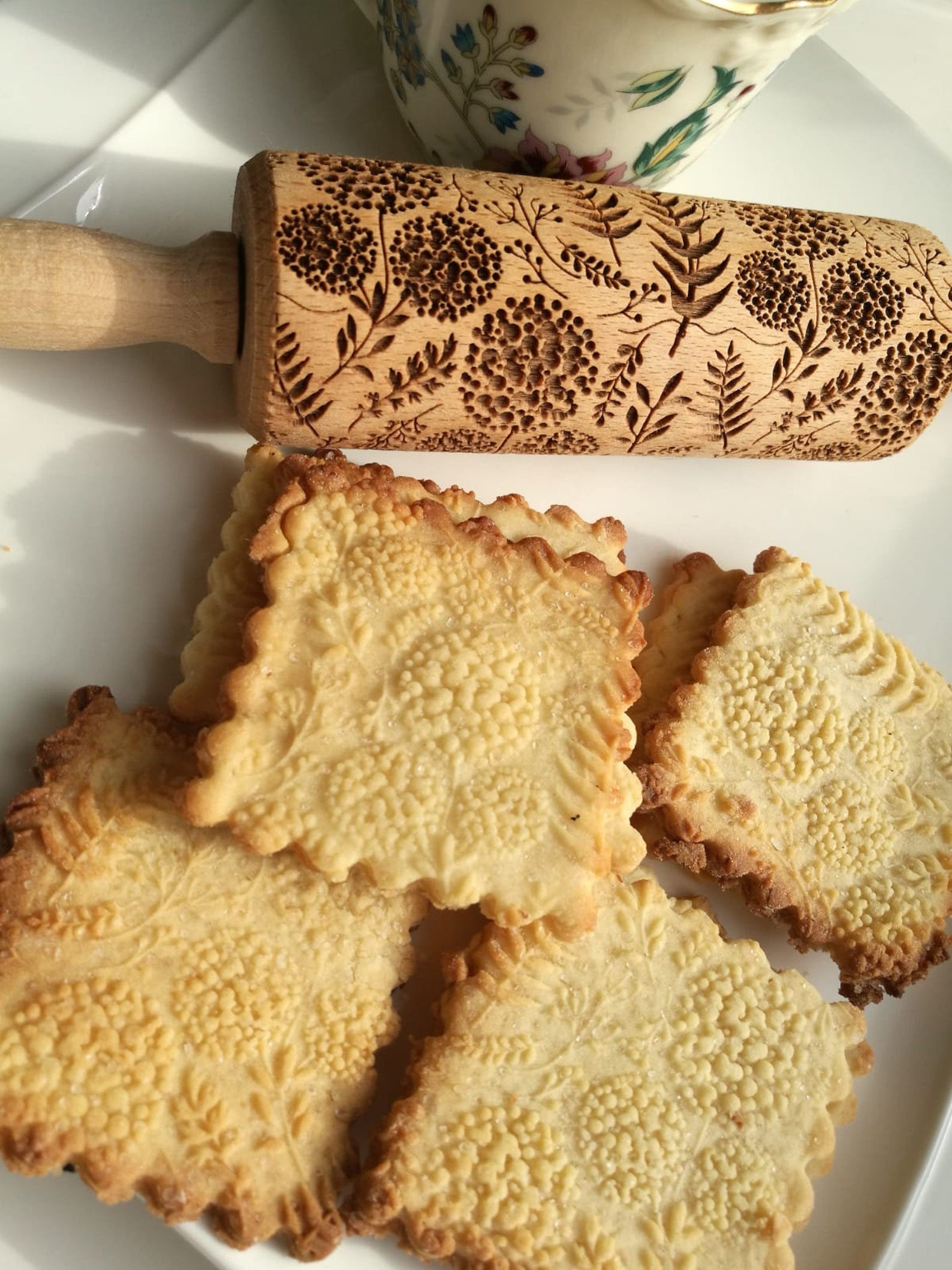 dandelion rolling pin with patterned shortbread cookies