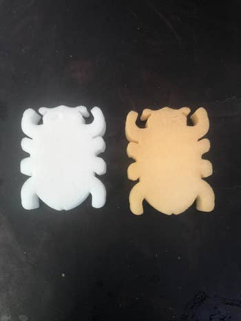 Two beetle-shaped sponges, one white and one brown from all the oils and grime picked up
