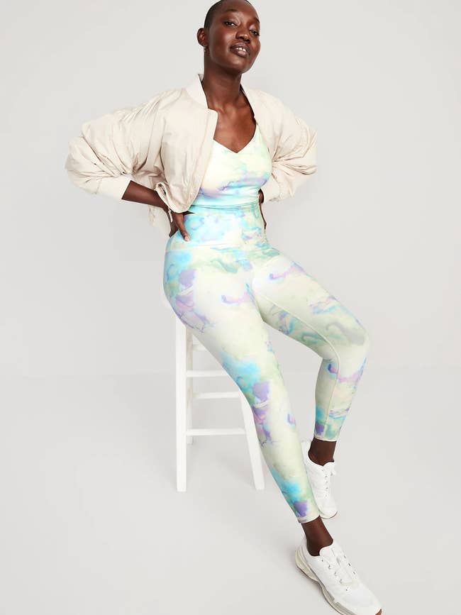 reviewer wearing the cream, purple, and blue marble leggings