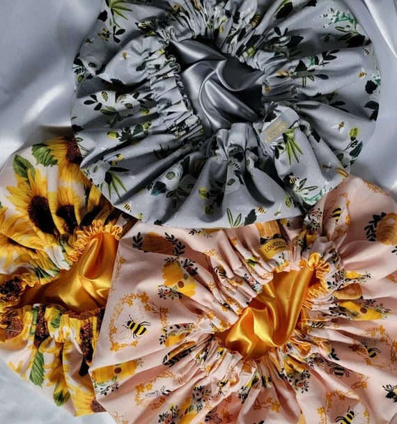 three satin bonnets in different colors and patterns