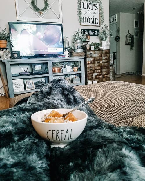 A reviewer cozied up with their throw blanket eating cereal