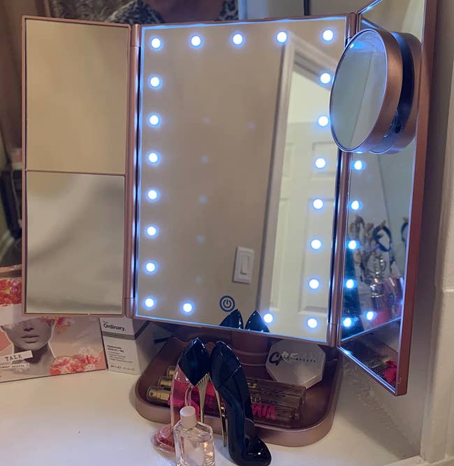 Reviewer's pink vanity mirror open and lit up