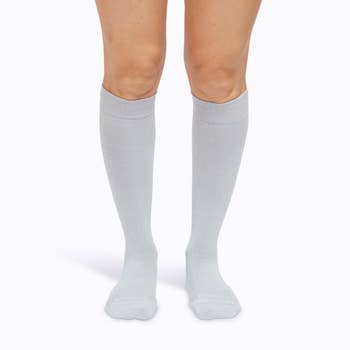 Model wearing grey compression socks