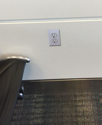a reviewer's outlet sticker stuck to a wall