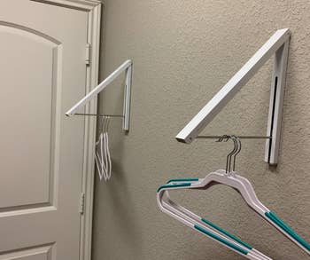 reviewer photo of the arms of the rack pulled down and several empty hangers hanging from them