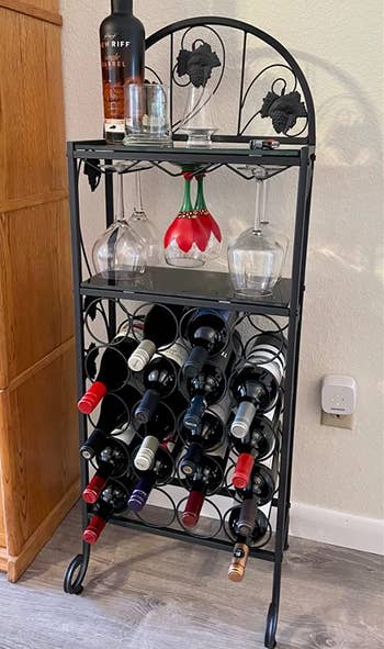 Reviewer image of the larger black wine stand with wine glasses and bottles