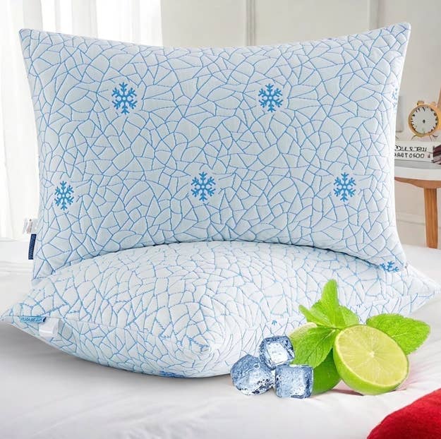Cooling pillow with a cracked crystal pattern, complemented by caller mint leaves, crystal cubes, and a lime slice, suggesting chill comfort
