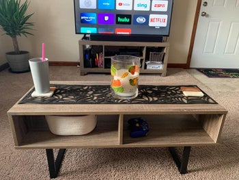 reviewer photo of wooden coffee table in front of tv