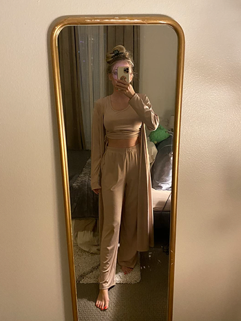 Reviewer mirror photo with tank top, pants, and robe in beige