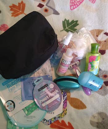 a reviewer photo of the bag next to a pile of toiletries 