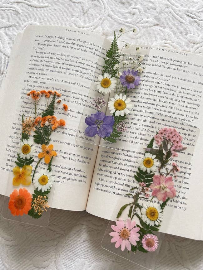 three floral bookmarks on an open book