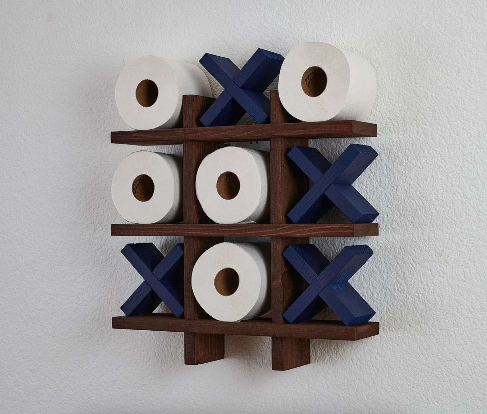 the tic tac toe toilet roll holder mounted on a wall
