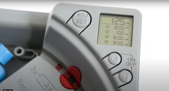 Close up of gray display screen on product with power button and personalization buttons