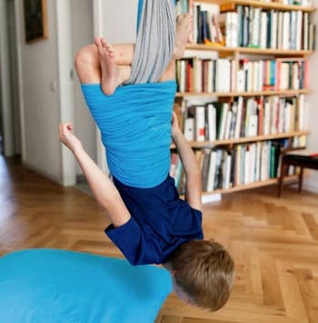 Different child using the chair while hanging upside down