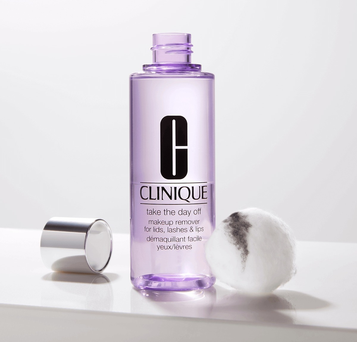 product image of the makeup remover next to dirty cotton ball