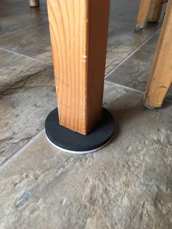 reviewer image of one of the sliders under a table leg