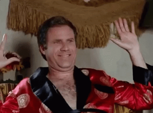Person successful a luxurious robe, delightfully smiling with raised hands indoors