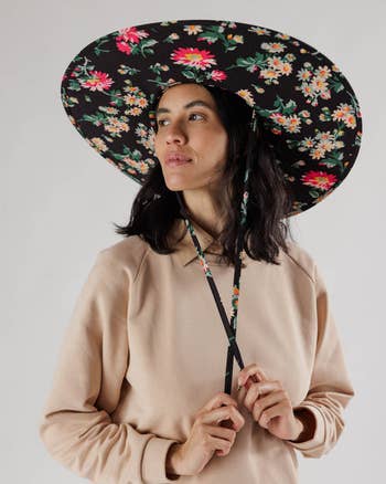 model wearing the black floral hat