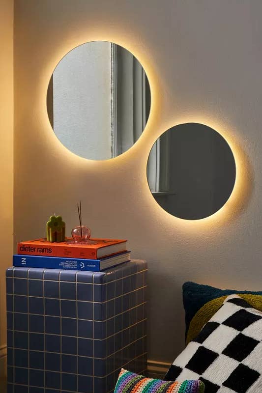 two of the round mirrors with lights on